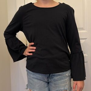 black long sleeve top with bell bottom sleeves.